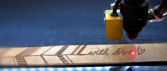 Laser beam engraving a design into wood